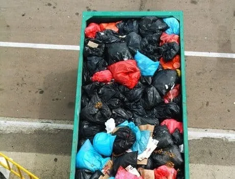 Cage of bagged household rubbish collected by Dartmouth Midi Skips for sorting