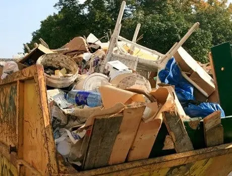 Skip loaded with mixed trade waste collected by Dartmouth Midi Skips
